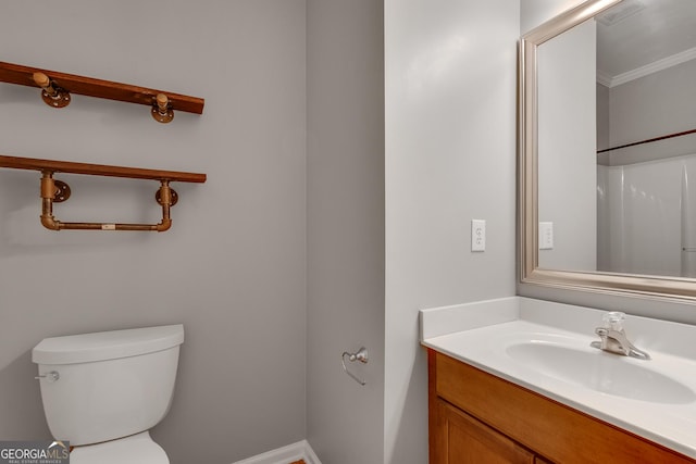 bathroom featuring visible vents, vanity, ornamental molding, and toilet
