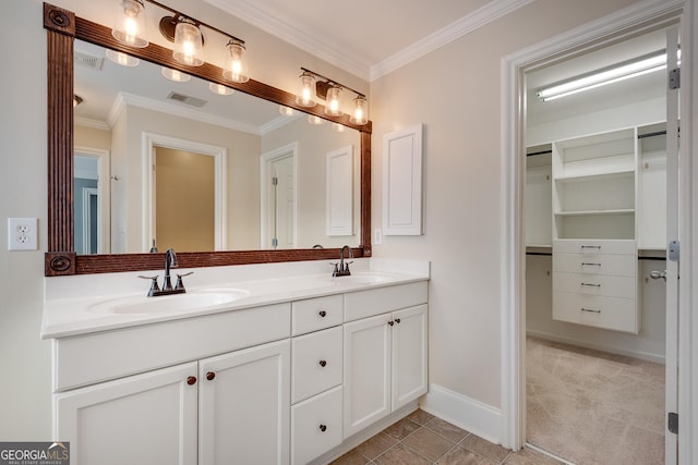 bathroom featuring visible vents, a sink, and ornamental molding