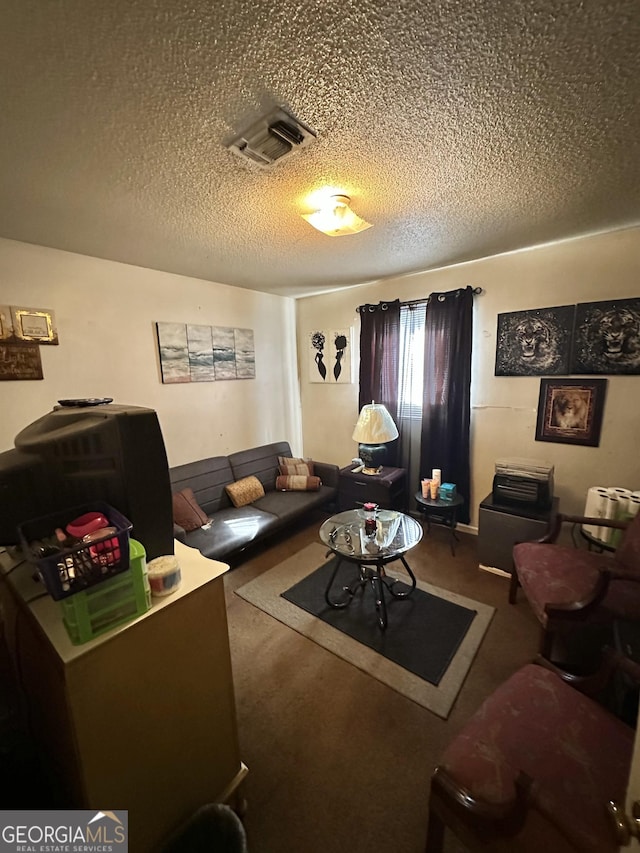 carpeted living room featuring a textured ceiling and visible vents