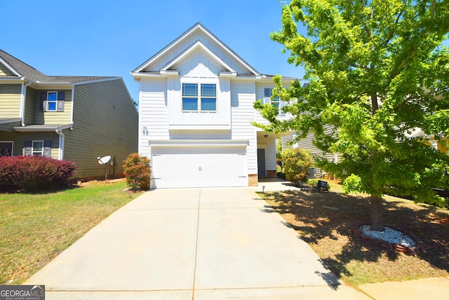 view of front of home with concrete driveway, a front lawn, board and batten siding, and a garage