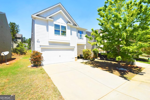view of front of house featuring board and batten siding, a front lawn, driveway, and a garage