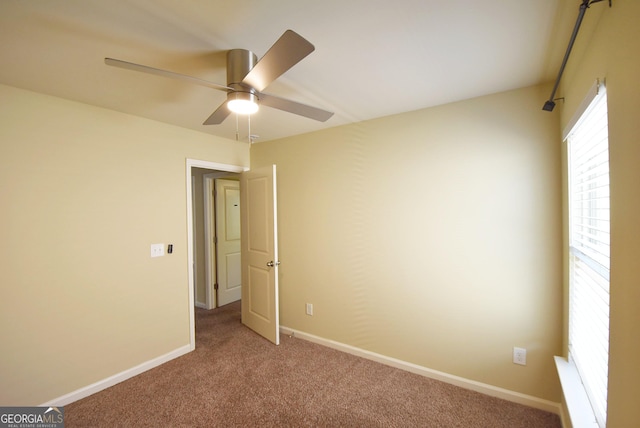 unfurnished bedroom with carpet flooring, baseboards, and a ceiling fan