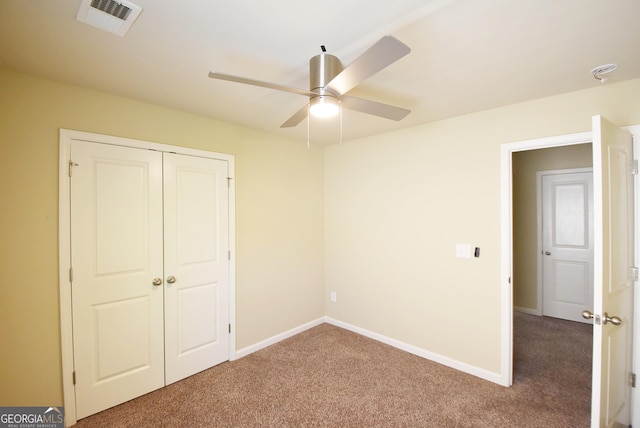 unfurnished bedroom with carpet floors, a closet, visible vents, and baseboards