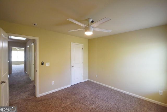 unfurnished bedroom featuring baseboards, carpet flooring, and ceiling fan
