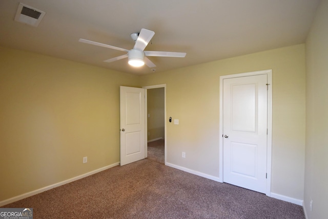 unfurnished bedroom featuring visible vents, carpet flooring, baseboards, and ceiling fan