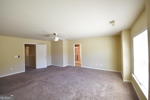 unfurnished room featuring dark carpet, baseboards, and a ceiling fan