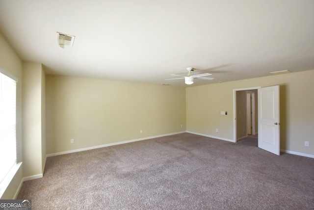unfurnished room featuring ceiling fan, carpet floors, visible vents, and baseboards