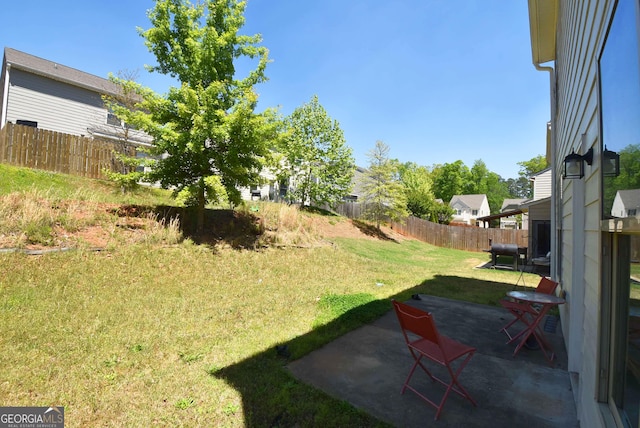 view of yard featuring fence and a patio