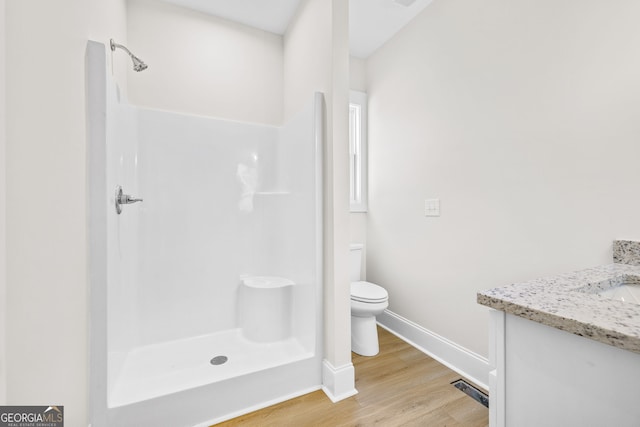 405 Roper Dr, Clarkesville, GA 30523 - full bath with wood finished floors, walk in shower, baseboards, toilet, and visible vents