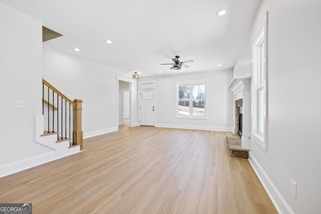 405 Roper Dr, Clarkesville, GA 30523 - unfurnished living room with recessed lighting, stairway, a fireplace with raised hearth, a ceiling fan, and light wood-type flooring