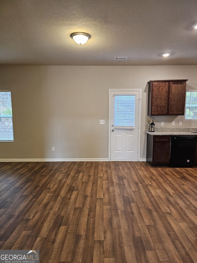 kitchen featuring dark wood-style flooring, dark brown cabinets, baseboards, visible vents, and dishwasher