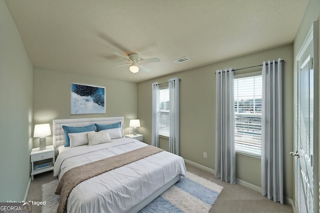 bedroom featuring ceiling fan, baseboards, visible vents, and carpet