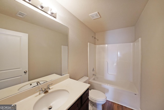 full bathroom with toilet, vanity, wood finished floors, and visible vents