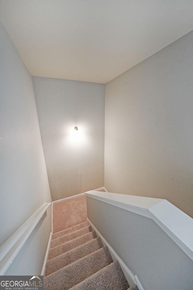 stairs with carpet flooring and baseboards