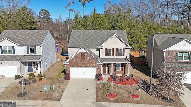 traditional home featuring brick siding and concrete driveway