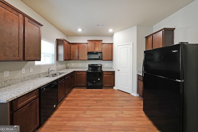 kitchen featuring a sink, black appliances, light wood-type flooring, visible vents, and recessed lighting