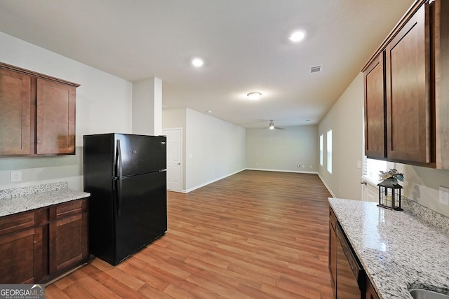 kitchen featuring visible vents, light wood-type flooring, black appliances, open floor plan, and ceiling fan