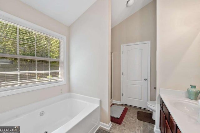 bathroom with a bath, a stall shower, toilet, vaulted ceiling, and vanity