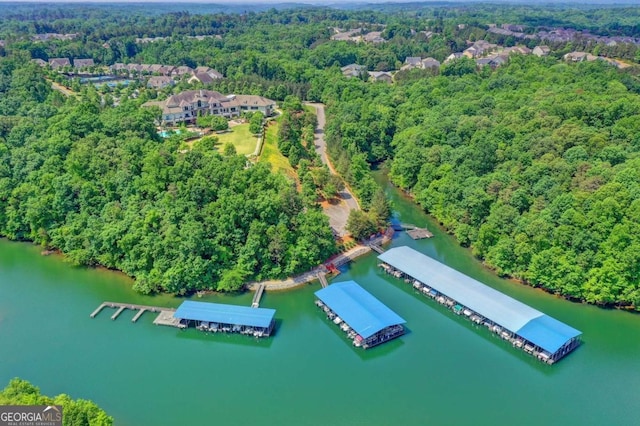 birds eye view of property featuring a view of trees and a water view