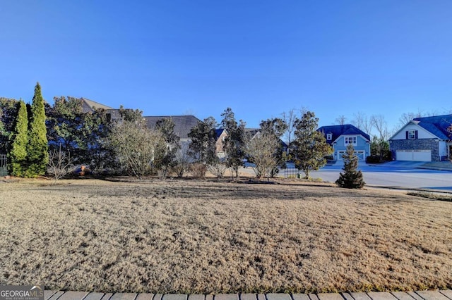 view of yard with a residential view and a garage