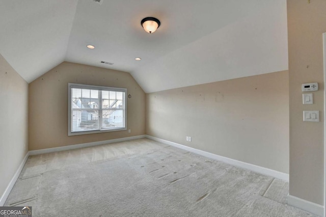 additional living space featuring carpet floors, lofted ceiling, visible vents, and baseboards