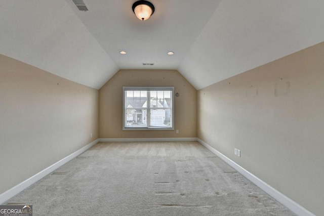 bonus room with carpet floors, vaulted ceiling, visible vents, and baseboards