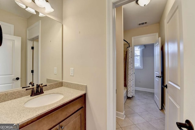 full bathroom featuring baseboards, visible vents, shower / bath combo with shower curtain, tile patterned flooring, and vanity