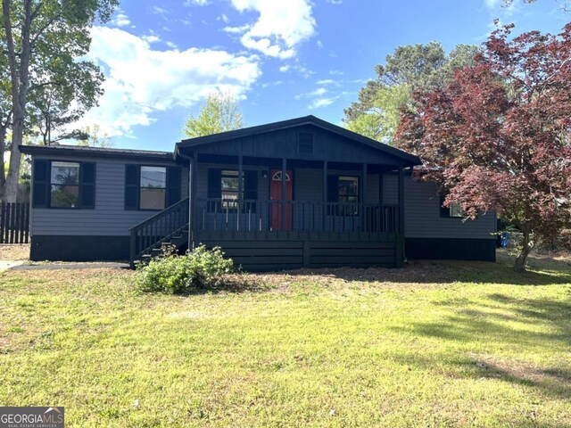 view of front of home featuring covered porch and a front yard