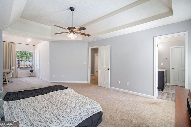 5 Stony Oak Dr, Newnan, GA 30263 - bedroom featuring a raised ceiling, light carpet, baseboards, ensuite bathroom, and a textured ceiling