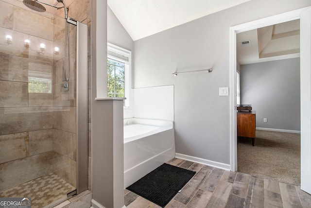 5 Stony Oak Dr, Newnan, GA 30263 - full bathroom featuring a bath, a stall shower, lofted ceiling, wood finished floors, and baseboards