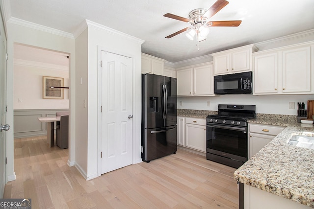 5 Stony Oak Dr, Newnan, GA 30263 - kitchen with black appliances, ceiling fan, light wood-type flooring, white cabinetry, and crown molding