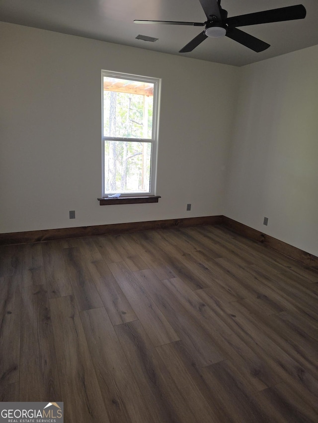 211 Lake Chase Dr N, Griffin, GA 30224 - empty room featuring dark wood-style flooring, ceiling fan, and baseboards