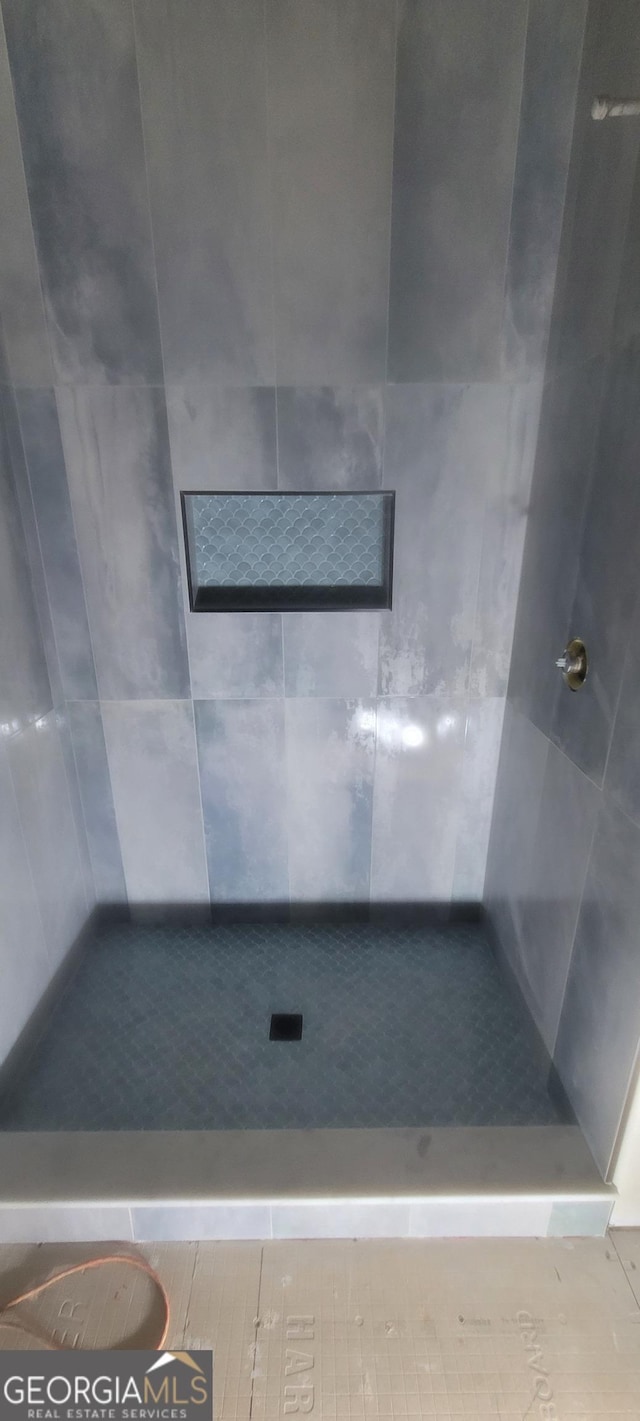 full bathroom with a tile shower