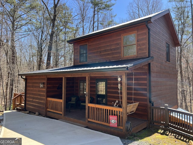 view of front of property featuring covered porch and metal roof