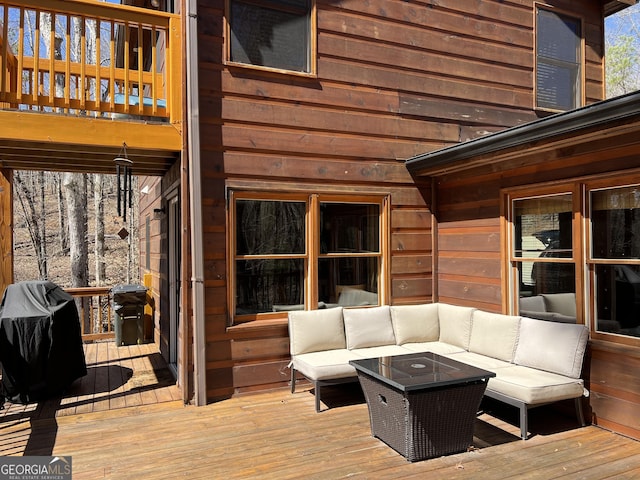 deck with area for grilling and an outdoor living space