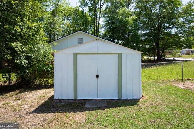 view of shed with fence