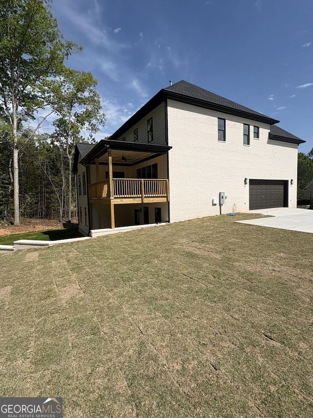 409 Saint Surrey Way, Ellenwood, GA 30294 - view of property exterior featuring a garage, a balcony, driveway, and a lawn