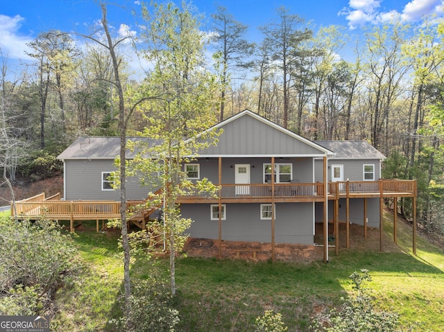 527 Abby, Clayton, GA 30525 - back of house featuring a deck, a yard, and a view of trees
