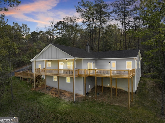 527 Abby, Clayton, GA 30525 - rear view of house featuring board and batten siding, a chimney, a wooden deck, stairs, and a lawn