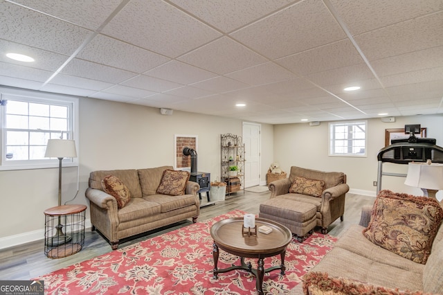 living area featuring baseboards, wood finished floors, and recessed lighting