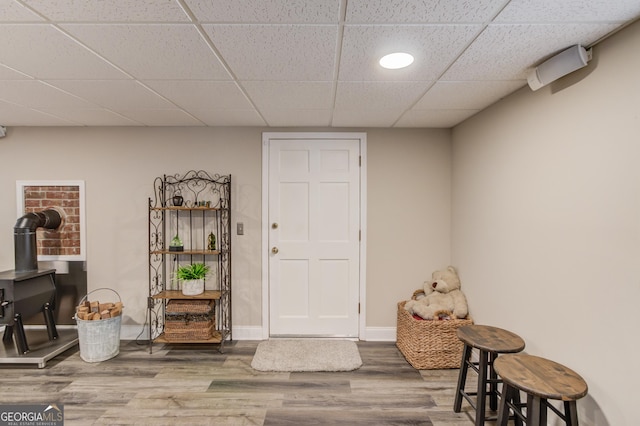 bathroom featuring toilet, a drop ceiling, baseboards, wood finished floors, and vanity