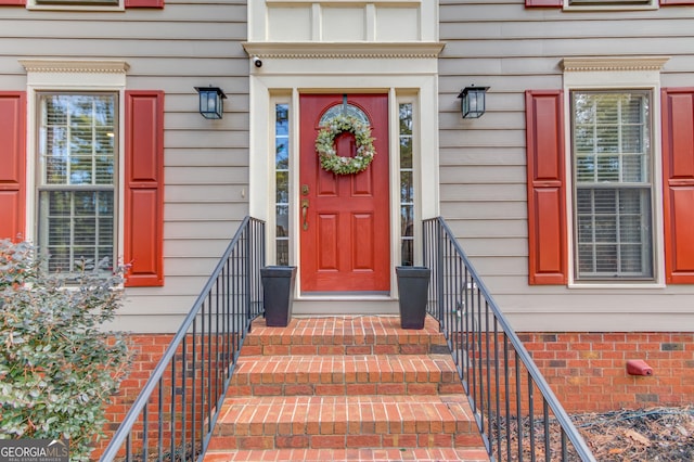 foyer entrance with baseboards, visible vents, a high ceiling, stairs, and dark wood-type flooring