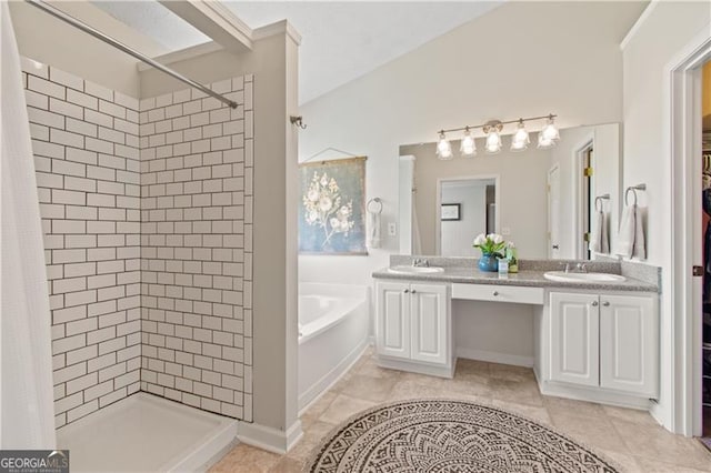 full bathroom featuring a sink, double vanity, a garden tub, and a shower stall