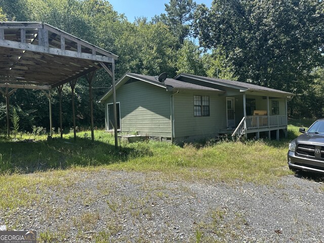 view of home's exterior featuring crawl space and a porch