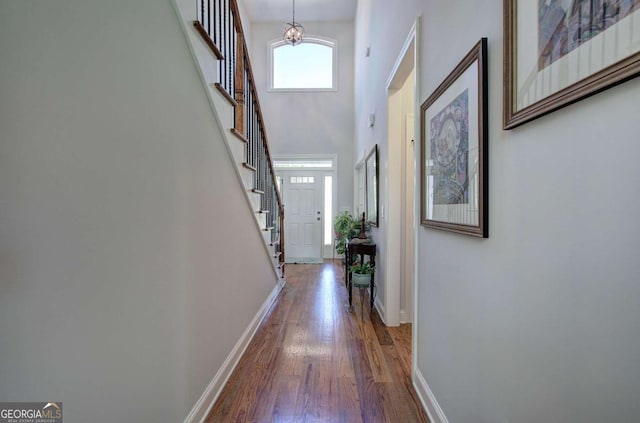 17 Ivy Stone Ct SE, Cartersville, GA 30120 - hall with stairway, baseboards, a towering ceiling, and wood finished floors