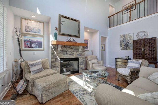 17 Ivy Stone Ct SE, Cartersville, GA 30120 - living area featuring baseboards, wood finished floors, a high ceiling, and a fireplace