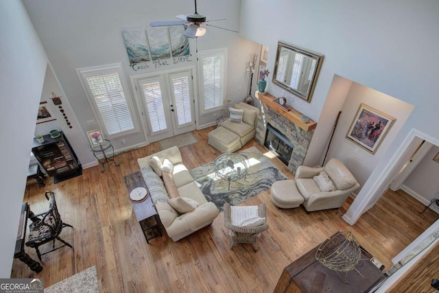17 Ivy Stone Ct SE, Cartersville, GA 30120 - living area featuring a fireplace, a towering ceiling, baseboards, and ceiling fan