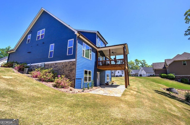 17 Ivy Stone Ct SE, Cartersville, GA 30120 - rear view of house with stone siding, a patio area, a lawn, a balcony, and ceiling fan