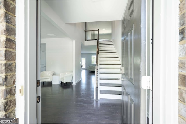 staircase featuring baseboards and hardwood / wood-style floors