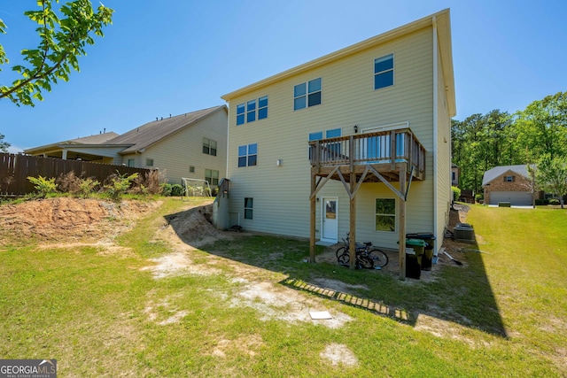 back of property with a lawn, central AC unit, and a deck